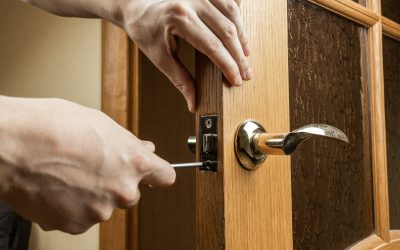 handyman fixing or repairing apartment wooden door lock. home furniture adjusting. door repair concept.